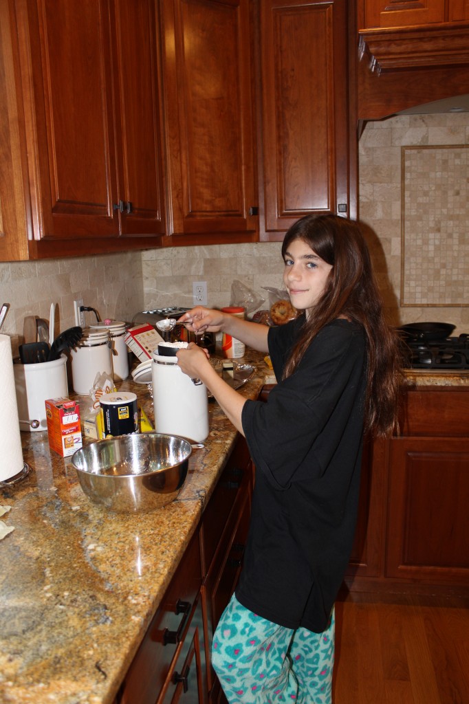 Lily Mesnik busily making delicious cakes for her bake sale. 