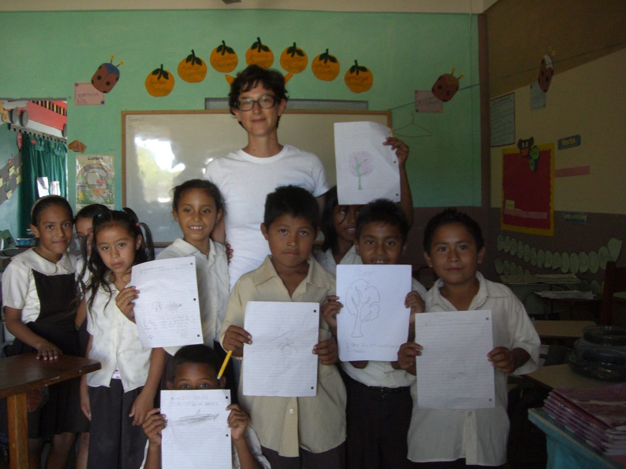 Nazarene school children proudly holding up their coral reef drawings