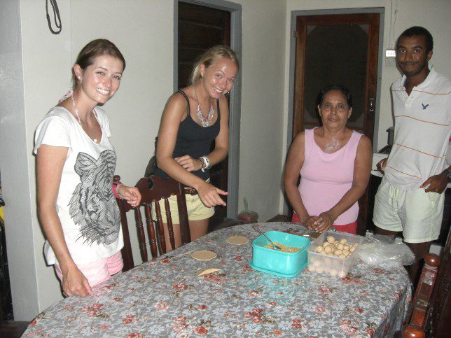 Volunteers Gill, Tom and Sophia with a Sartenejan woman who kindly teaches how to make the flat, round, ready to fold-over corn dough for empanadas