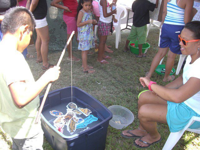 Our volunteer, Casey keeps the time while a young participant has to quickly decide which fish he will go for