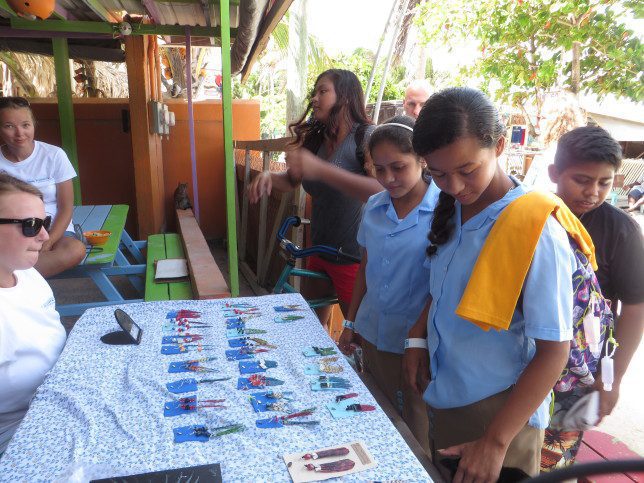 local children admiring the lionfish earings