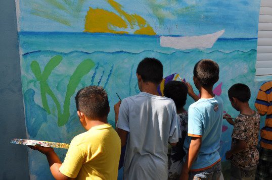 Sarteneja children eagerly seizing the opportunity to contribute to the Blue Ventures office mural at the Reef Party. With outstretched pinkies and a perfectly balanced palette they are professional artists already!  