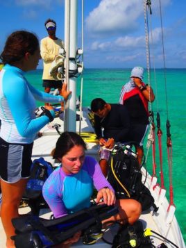 Lionfish survey team gearing up to get in the water! L-R: Anna (BV), Julia (BV), Eli (BAS), and Tanya (TIDE). Capt. Brian overseeing in the background! Photo credit: Regina (Brujula Sailing Trips and Transport)